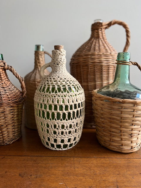 Antique wicker store wrapped bottles